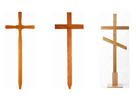 Grabkreuze in geschwungener und gerader Form aus verschiedenen Materialien wie Holz und Metall.